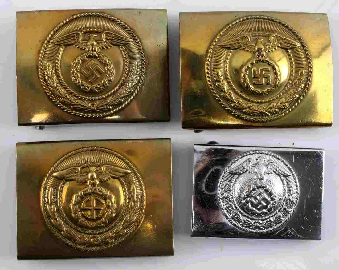 WWII GERMAN THIRD REICH NSDAP BELT BUCKLE LOT OF 4: WWII German Third Reich NSDAP Belt Buckle lot of four. Lot includes three brass NSDAP belt buckles and one steel NSDAP belt buckle. There is slight oxidation on the brass buckles and patina on the ste