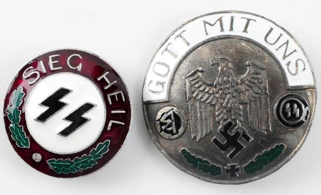 WWII GERMAN 3RD REICH SS ENAMELED BADGES LOT OF 2: Lot of two German SS enamel badges. One with black SS insignia, green oak leaves, and "SIEG HEIL" inscription on a red background. The other has a Reichsadler in center with black swastika, black SS i