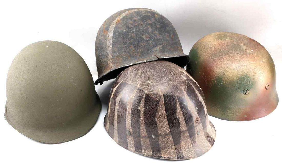 LOT OF WWII HELMETS AND LINERS SOME REPRODUCTION: Lot includes: camo painted M38 with leather liner (repro), couple M1 helmets (one with stripe across front) and one looks modern with canvas strap, plus one WWII striped liner. Condition varies.