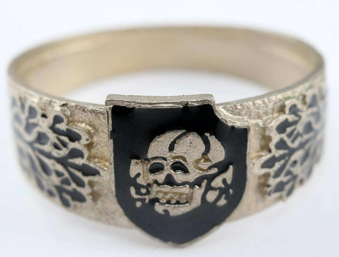 WWII GERMAN 3RD SS DIVISION TOTENKOPF SILVER RING: German 3rd SS Panzer Division Totenkopf silver ring with Heinrich Himmler signature engraved on inside. Enameled relief of 3rd SS Panzer Division Totenkopf shield on face and oak leaves on both sides.