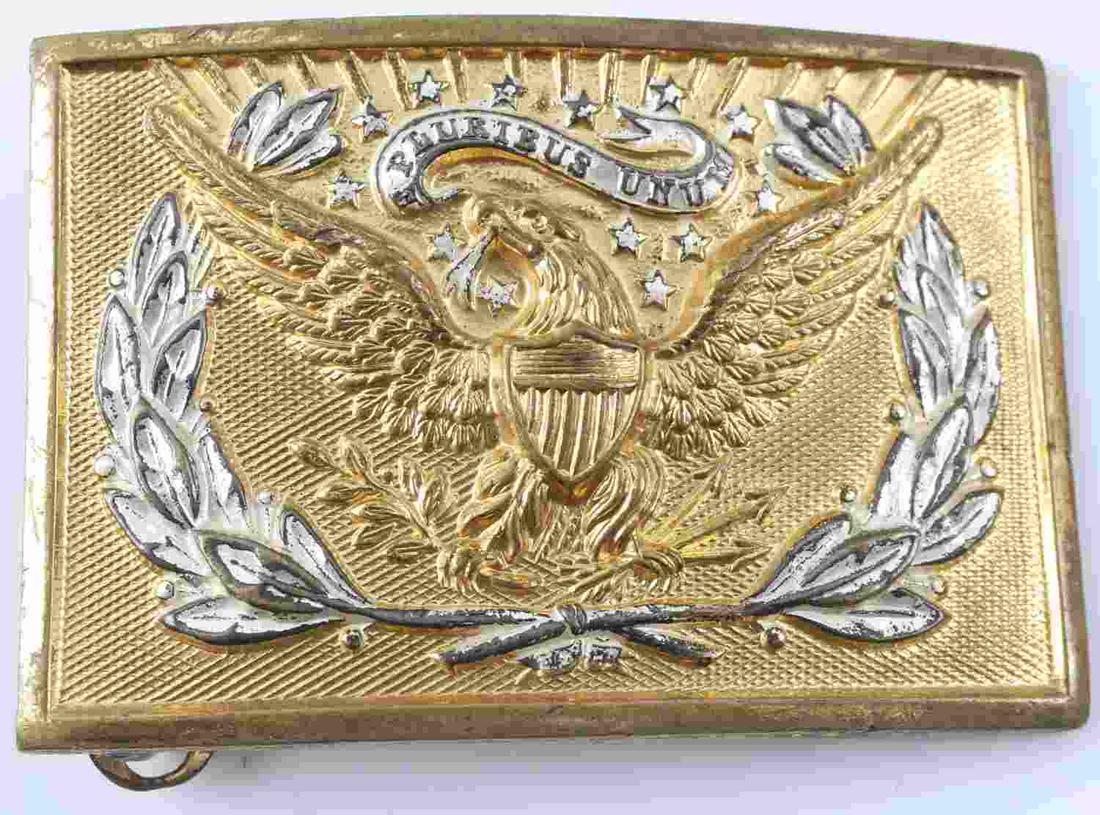 US INDIAN WARS ARMY EM BELT BUCKLE PLATE: US Indian Wars Army EM Belt Buckle Plate. Measures 2 7/8” wide by 2” tall. The front shows the classic American eagle clutching oak leaves and three arrows in his talons. It reads ‘E Pluribus Un
