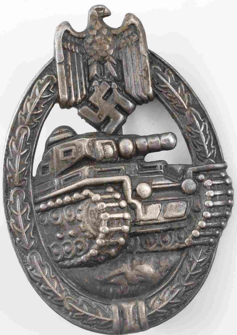 WWII GERMAN ARMY HEER SILVER TANK ASSAULT BADGE: German WWII Army Silver Tank Assault Badge. The front shows a tank in the center with an army eagle clutching a swastika in his talons at the top. Both are surrounded by an oval oak leaf wreath. Has a