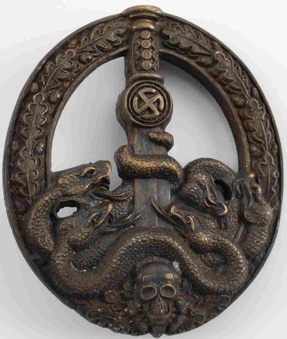 WWII GERMAN ARMY HEER BRONZE ANTI PARTISAN BADGE: WWII German Heer Anti Partisan badge in good condition. The front shows 5 snakes on the lower part wrapped around a sword blade with a skull at the base. All 6 are surrounded by an oval oak leaf wreat