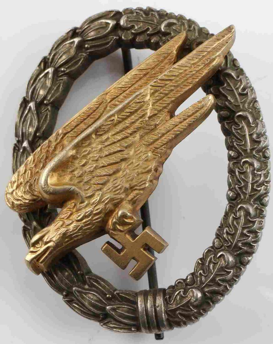 WWII GERMAN SS LUFTWAFFE PARATROOPER JUMP BADGE: German WWII Luftwaffe Paratrooper Fallschirmjager Jump Badge. Maker marked ‘G H Osang Dresden’. Has a thin vertical ‘T’ bar style pin back. Two piece two domed rivet nickel and brass construct