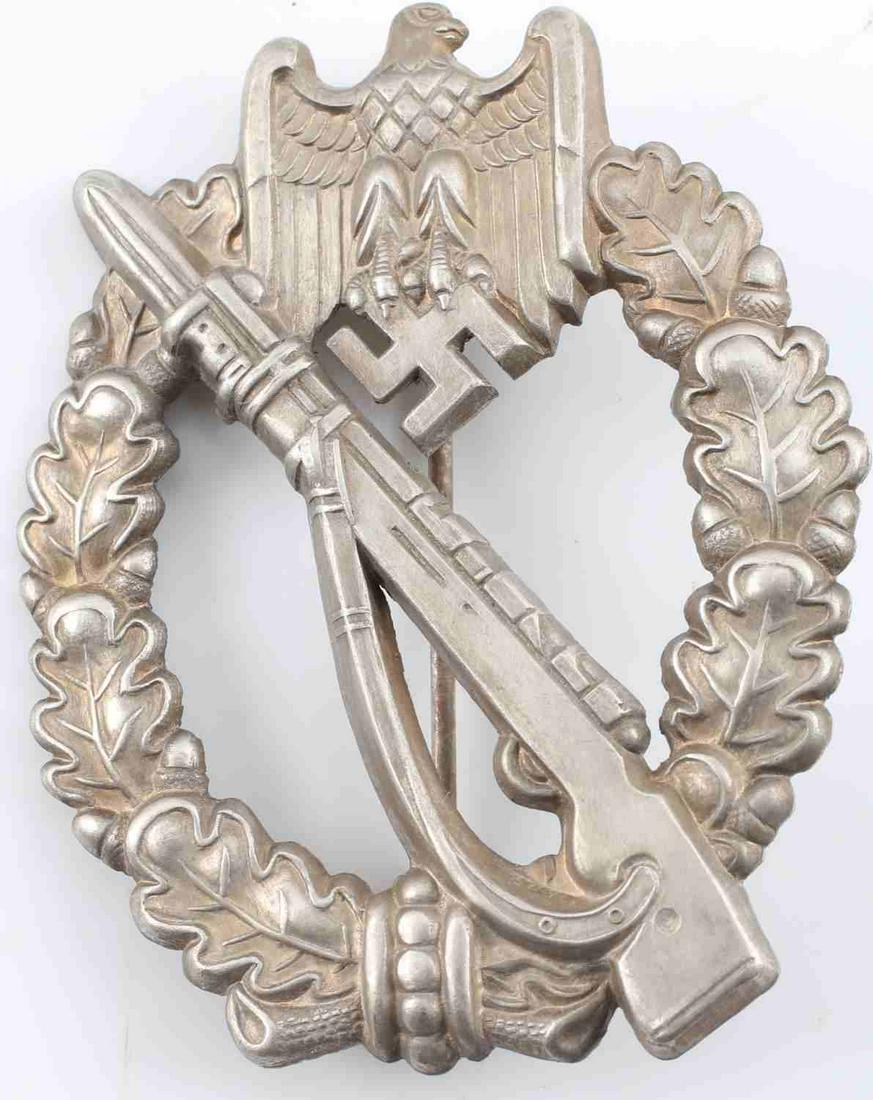WWII GERMAN SS WEHRMACHT INFANTRY ASSAULT BADGE: German WWII Army Silver Infantry Assault Badge. The front shows a Mauser K-98 rifle in the center with a German eagle with a German eagle clutching a swastika in his talons at the top. Both are surrou