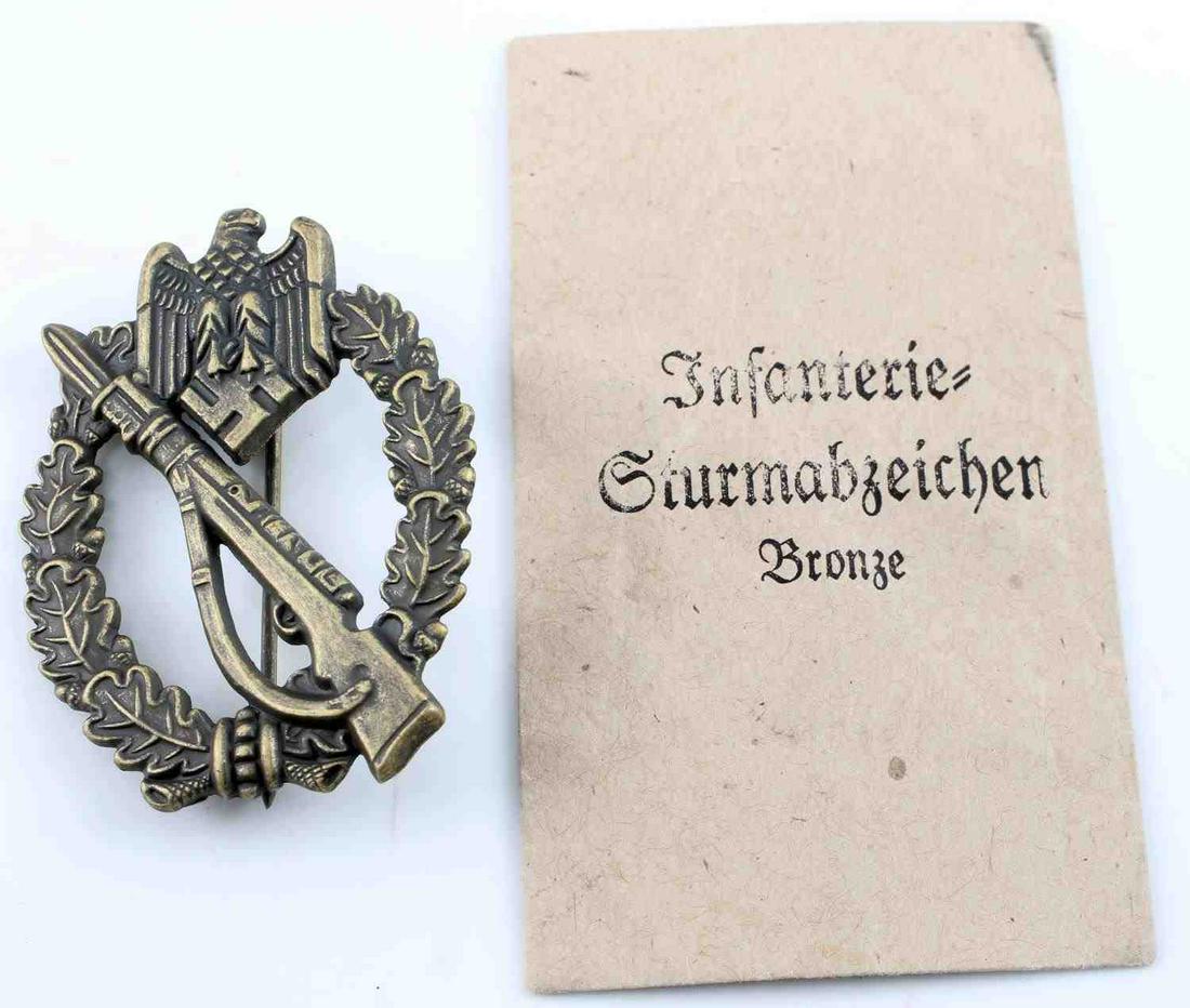 WWII GERMAN SS HEER BRONZE INFANTRY ASSAULT BADGE: German WWII Heer Army Bronze Infantry Assault Badge. The front has a Mauser K-98 rifle in the center with an army eagle clutching a swastika in his talons at the top. Both are surrounded by an oval oa