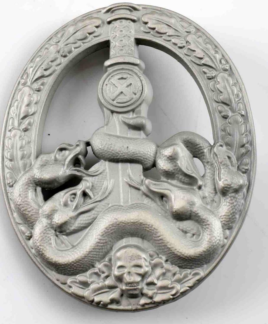 WWII GERMAN SS HEER SILVER ANTIPARTISAN BADGE: German WWII Army Heer Silver Anti Partisan Badge. The front shows five snakes on the lower part wrapped around a sword blade with a skull at the base. All six are surrounded by an oval oak leaf wreath