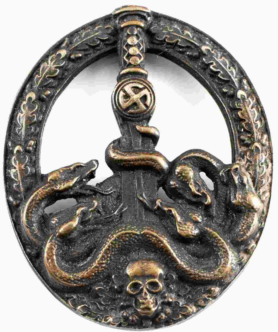 GERMAN WWII THIRD REICH ANTI PARTISAN BADGE: German WWII Army Heer Bronze Anti Partisan Badge. The front shows five snakes on the lower part wrapped around a sword blade with a skull at the base. All six are surrounded by an oval oak leaf wreath