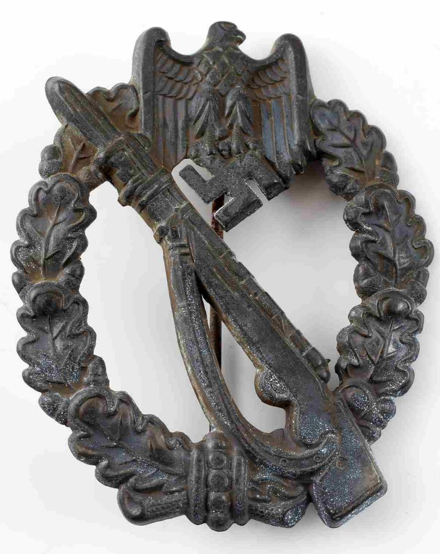 GERMAN WWII ARMY BRONZE INFANTRY ASSAULT BADGE: German WWII Army Bronze Infantry Assault Badge. The front has a Mauser K-98 rifle in the center with an army eagle clutching a swastika in his talons at the top. Both are surrounded by an oval oak lea