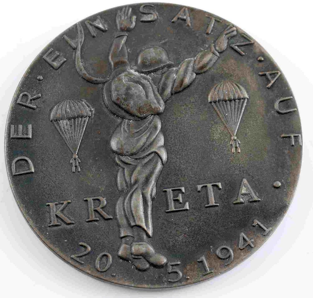 GERMAN WWII LUFTWAFFE 1941 KRETA TABLE MEDAL: German WWII Luftwaffe 1941 Silver KRETA Paratrooper Fallschirmjager Table Medal. Measures 2 1/4 inches in diameter. The front reads ‘Der Ein Satz Auf KRETA 20.5.1941’. It shows three paratroopers 