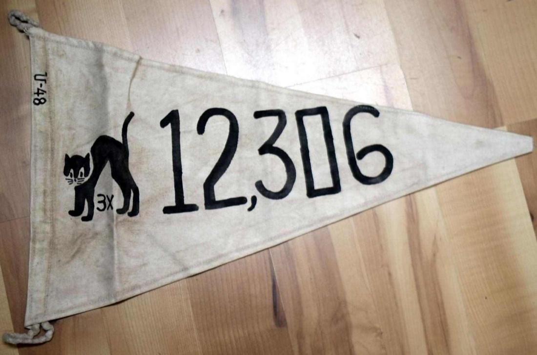 GERMAN WWII NAVAL KREIGSMARINE U-BOAT TONNAGE FLAG: German WWII Naval Kriegsmarine U-Boat Submarine Tonnage Kill Flag. Measures 22.125 inches wide by 13.125 inches tall. The front shows a black cat with ‘3X’ below. The side reads ’12,306’. The 