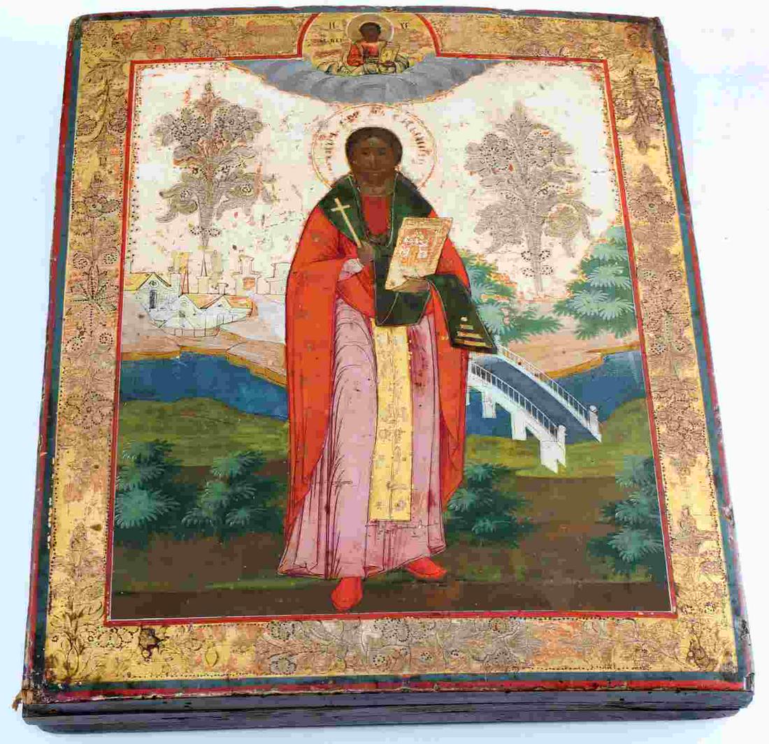BEAUTIFULLY PAINTED ANTIQUE WOOD ICON OF SAINT: Painted icon on curved wood panel. Very nicely rendered. Inscription identifying saint is slightly worn. Likely John the Baptist against a landscaped background. Some wear to paint evident and commens