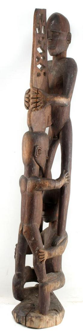 ASMAT IRIAN JAYA BIS POLE 3 MALE ANCESTOR FIGURES: Three nude ancestor figures stacked. Measures approximately 38 inches tall. The base is not level and has a crack measuring 1.5 inches. Very good condition.