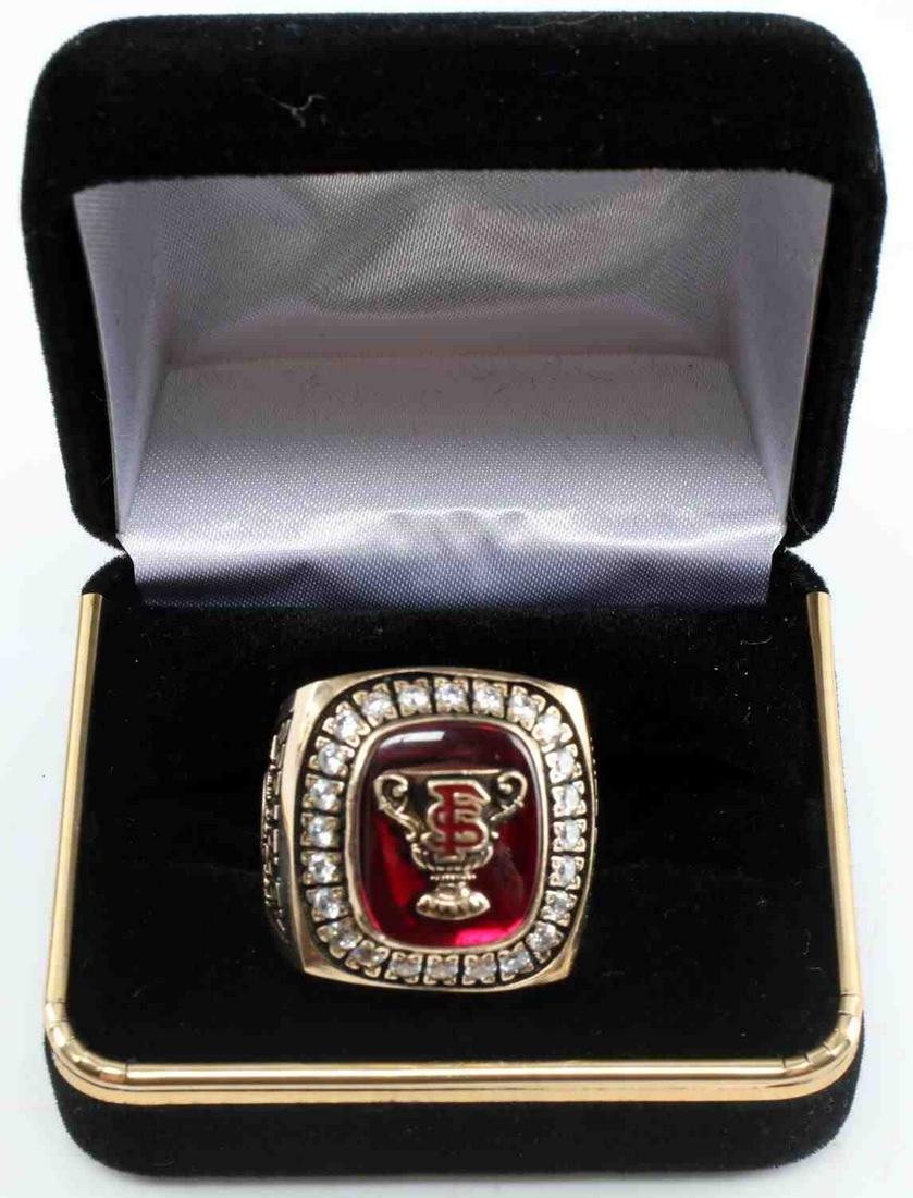 FLORIDA STATE SPRADLEY SUGAR BOWL 10K GOLD RING: FSU Super Bowl Championship ring 2000, features 24 2mm round cut CZ stones surrounding rectangular red stone with trophy cup and FS to center, Sugar Bowl Champions FS 2000 VT 46-29 engraved to right s