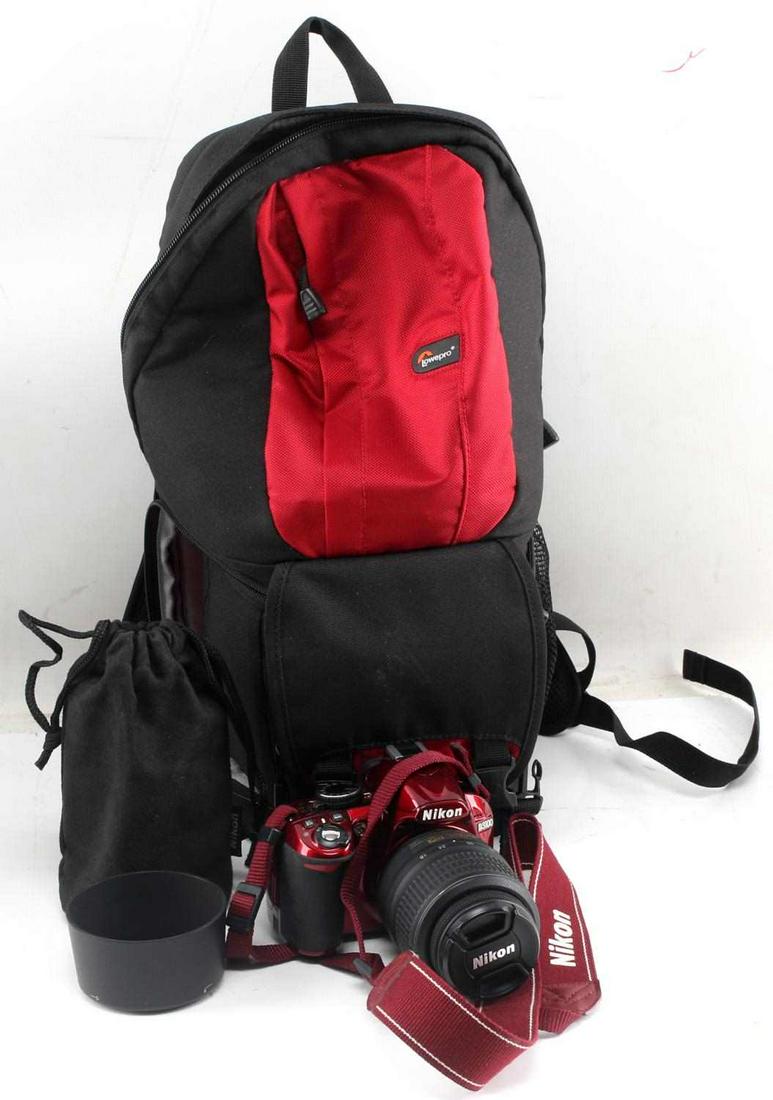 NIKON D3100 W DX 18 55 MM & 55 200 MM LENS & EXTRA: Shiny red Nikon camera body with Nikon 18-55 mm lens attached, Nikon 55-200 mm lens in separate holder, charger, UV filter, lens hood and camera backpack. All in very good condition.