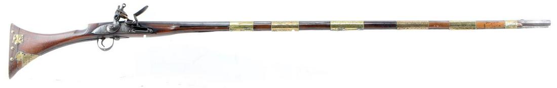 ANTIQUE BRITISH FLINTLOCK TOWER RIFLE .59 CAL: Features a 46.75 inch octagon barrel, wood stock and brass fittings. Lock plate marked GR with faint crowns above and broad arrow and crown to the right, Tower marked behind hammer. Other symbol marks