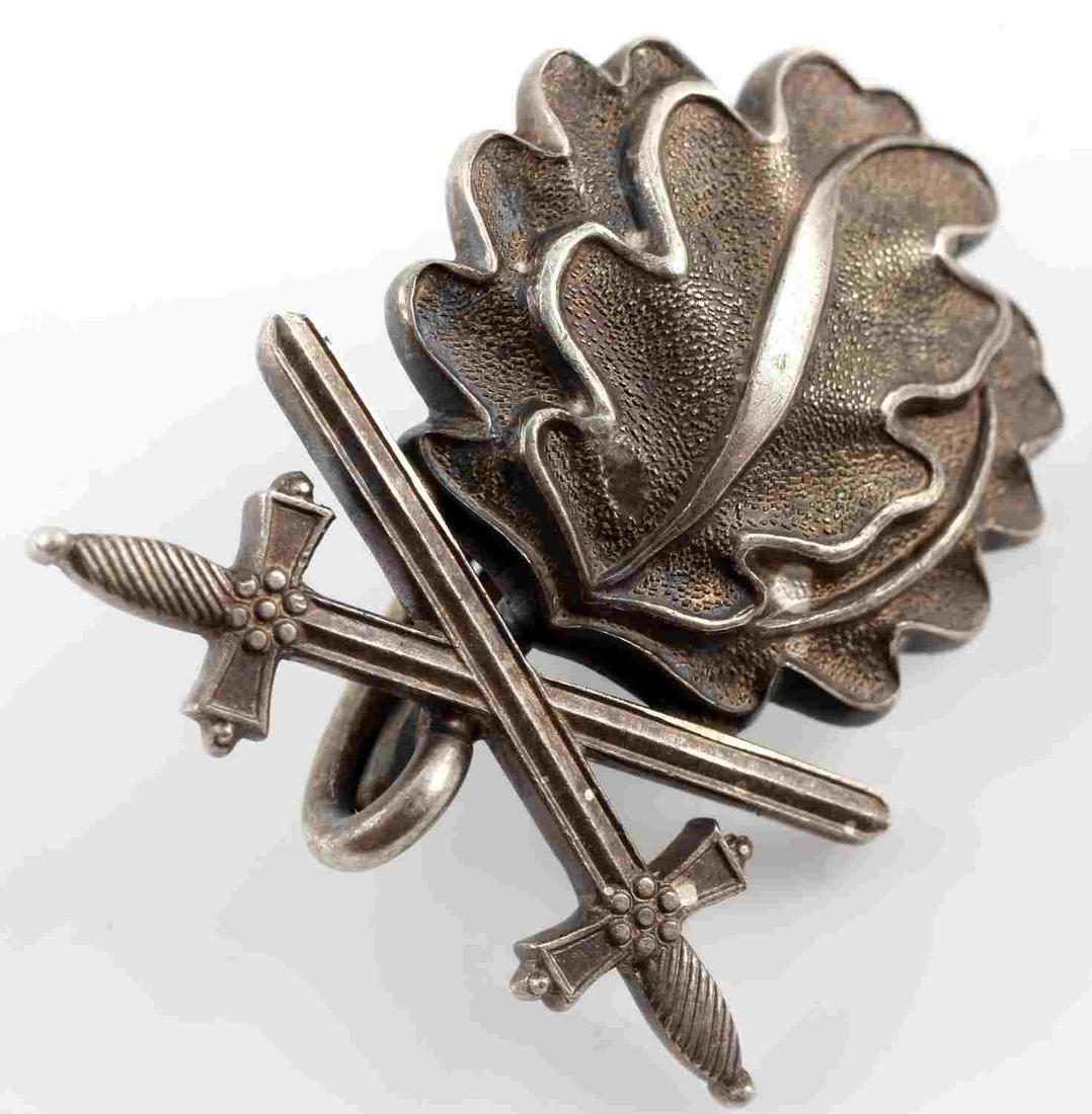 GERMAN KNIGHTS CROSS OAK LEAVES AND SWORDS: German Oak Leaves and Swords to the Knight's Cross from an Iron Cross. Marked "800" for silver content on reverse. Additionally marked "L/12." Very good condition overall. Unauthenticated; sold as is.