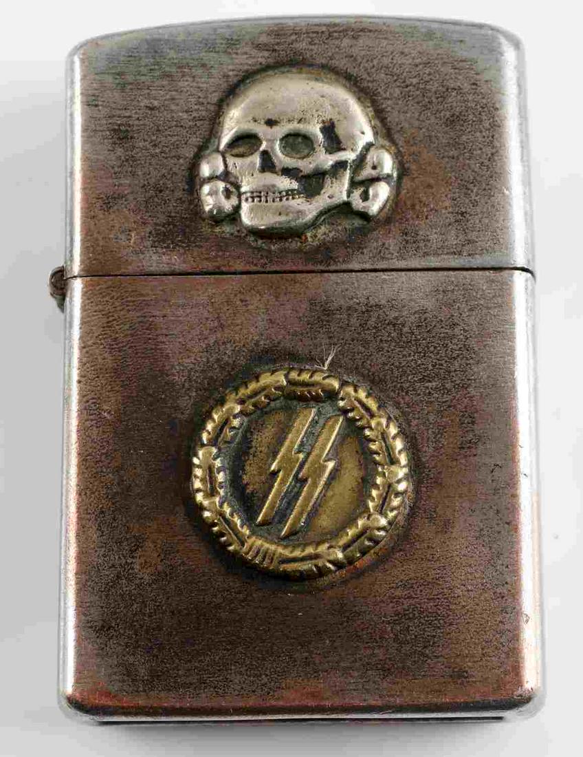 WWII GERMAN 3RD REICH WAFFEN SS CIGARETTE LIGHTER: Waffen SS marked cigarette lighter. Has a Totenkopf on the lid, sig runes on the body, and RZM mark on the base. In very good condition overall, still sparks. Unauthenticated/Sold 'as is' This lot has