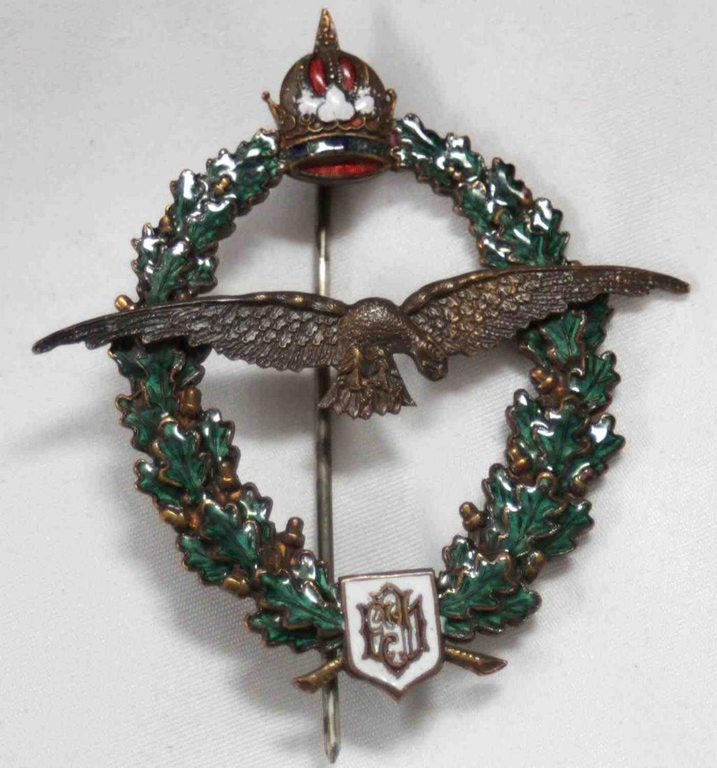 WWI AUSTRIAN MONARCHY ENAMELED PILOT BADGE: WWI Austro-Hungarian Pilot's badge from Franz Joseph era. Shows eagle surrounded by crowned oak wreath. The enamel on wreath and crown is in very good condition. Measures 2.5 inches tall and 2.375 inc