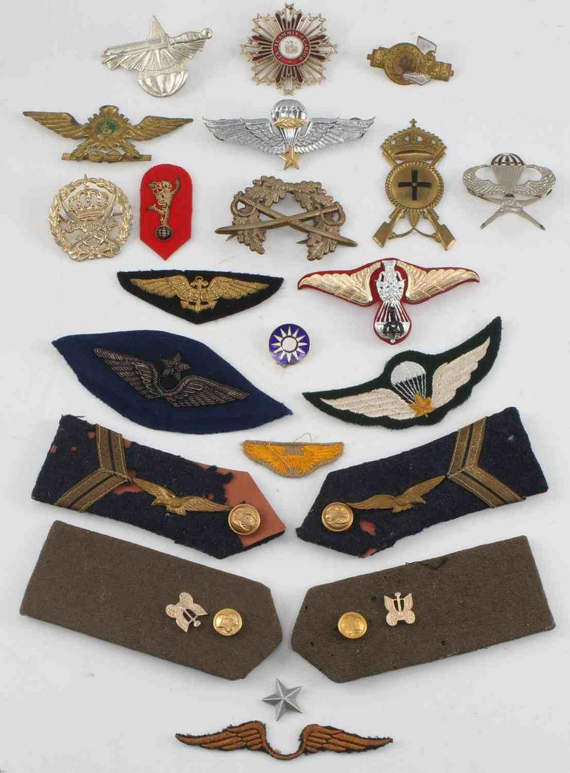 WWII AXIS & ALLIED POWERS LOT OF BADGES & PATCHES: Lot of 22 WWII Axis and Allied Powers badges and patches. 1 USAAF Instructor Wing patch. 1 Italian Facist Fasces with shield and sword pin, measuring 2 inches tall by 1.2 inches wide missing a pin. 1 