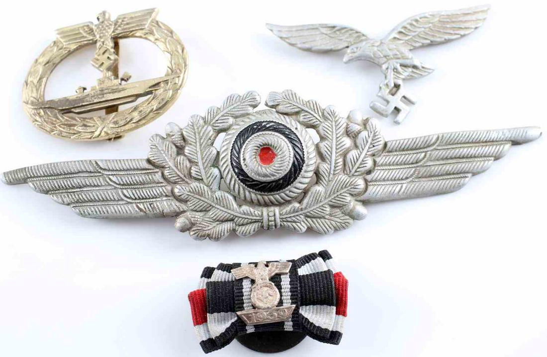 WWII THIRD REICH LUFTWAFFE INSIGNIA U BOAT BADGE: Two silver-colored Luftwaffe visor hat metal insignia. One insignia, measuring 2.5 inches by 1 inch, is composed of the eagle and the Swastika symbol and is marked "1/42" on back. The second, measurin