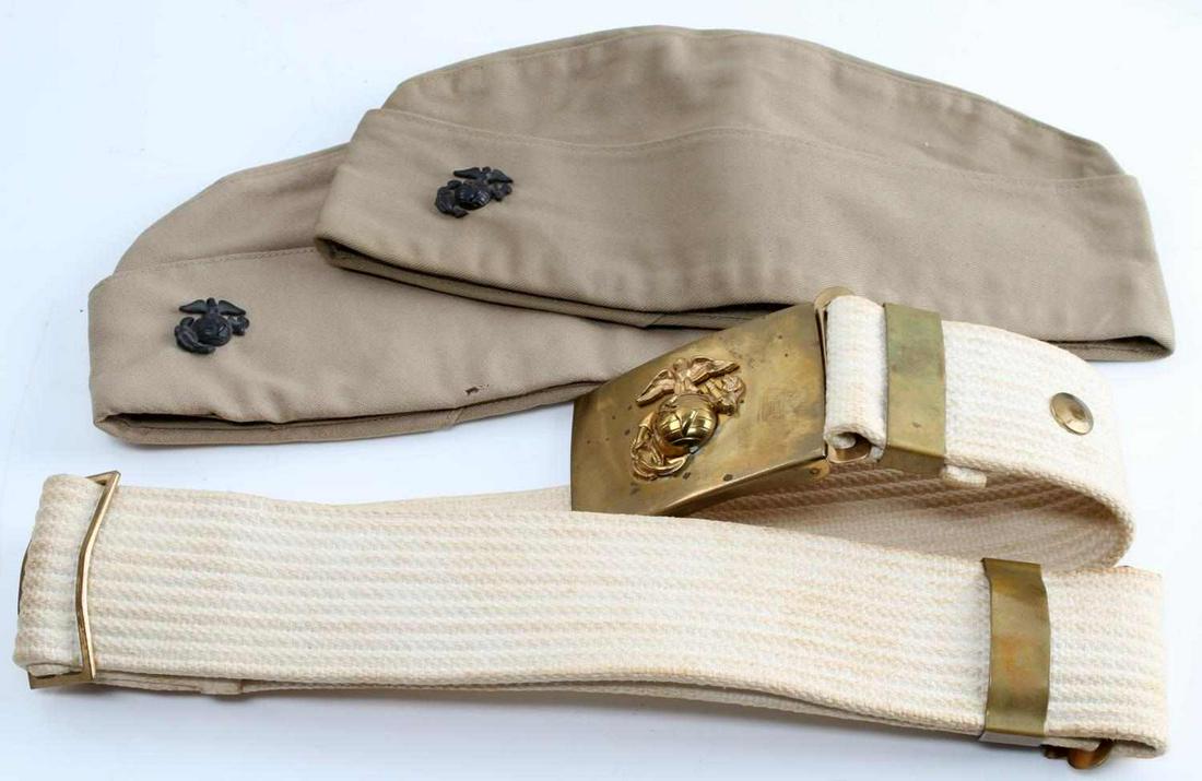 LOT OF WWII UNITED STATES MARINE CORPS BELT & CAP: Lot of 2 WWII USMC Garrison caps and USMC cotton web belt with brass buckle. Garrison caps include USMC insignia pin and are both size "7 1/4" and have some holes and staining present. Stamped "H Horn
