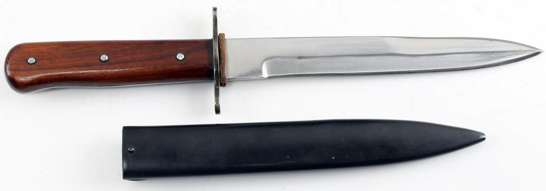 WWII GERMAN THIRD REICH SOLDIER BOOT KNIFE: WWII German Third Reich Soldier Boot Knife. The blade measures 7 inches while, the entire knife measures 11.25 inches. The handle is composed of wood. Includes a black metal scabbard. Very good condit
