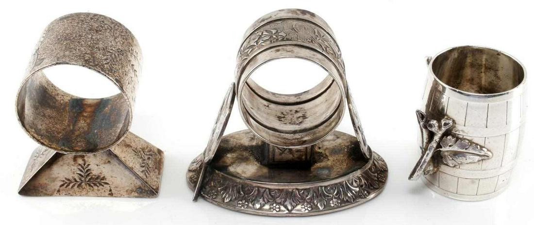 MERIDEN SILVER FIGURAL NAPKIN RING LOT OF 3: Includes Asian fan 290, 130, and a unmarked possibly Sterling barrel and leaf ring this alone weighs 99 grams.