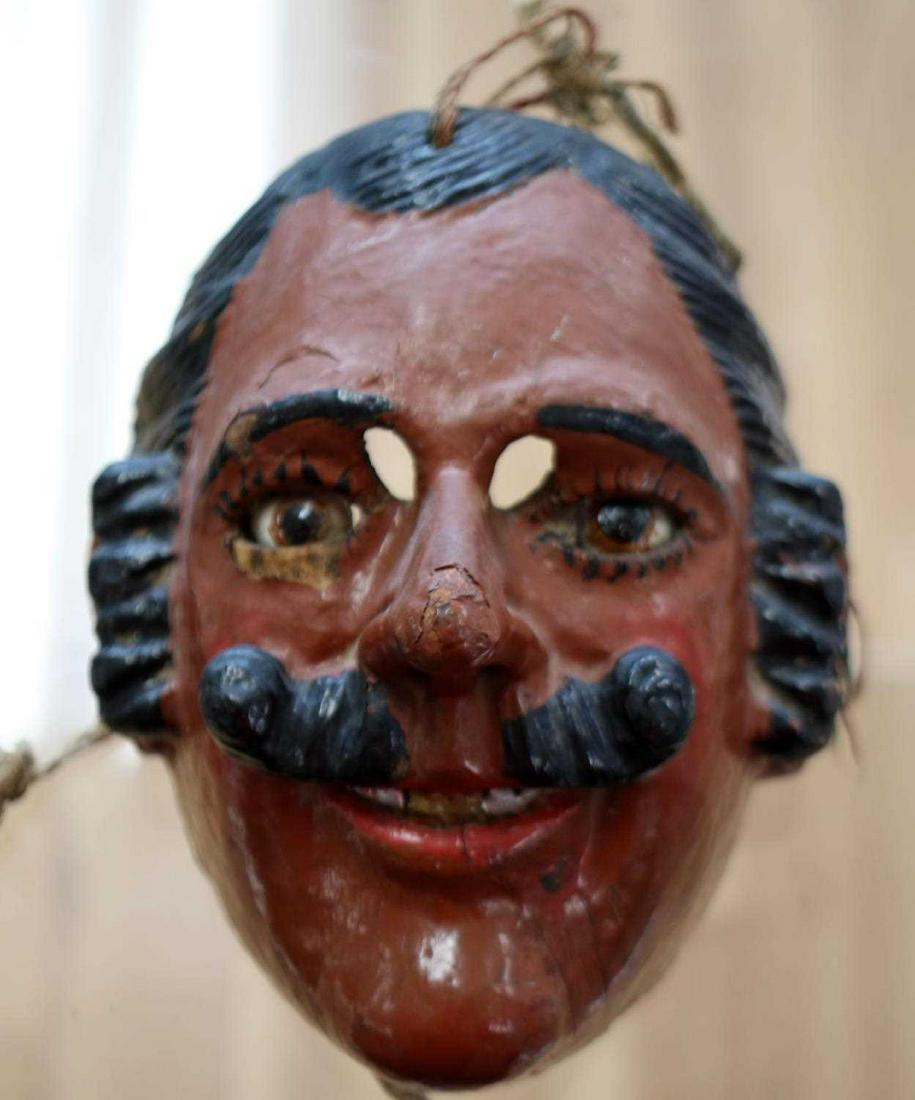 19TH C. CARVED GUATEMALAN WOODEN DANCE MASK: Hand-carved wooden mask with black hair, pointed nose and glass eyes. Hanger to back. Measures 7 X 6 X 6 inches. Eyes are fragile, may fall out. Some chipping of paint. Overall good condition. Provena