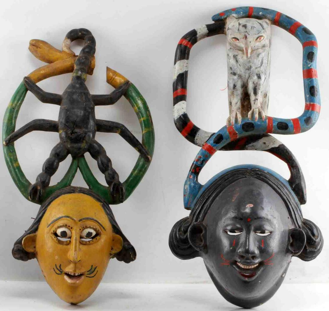 LOT OF TWO ANANG IBIBIO NIGERIA POLYCHROME MASKS: One wood mask with scorpion surrounded by snakes. Measures 22.5 inches by 5.5 inches by 12 inches. Missing part of the snake head. One showing owl surrounded by snakes. Measures 25 inches by 8 inches 