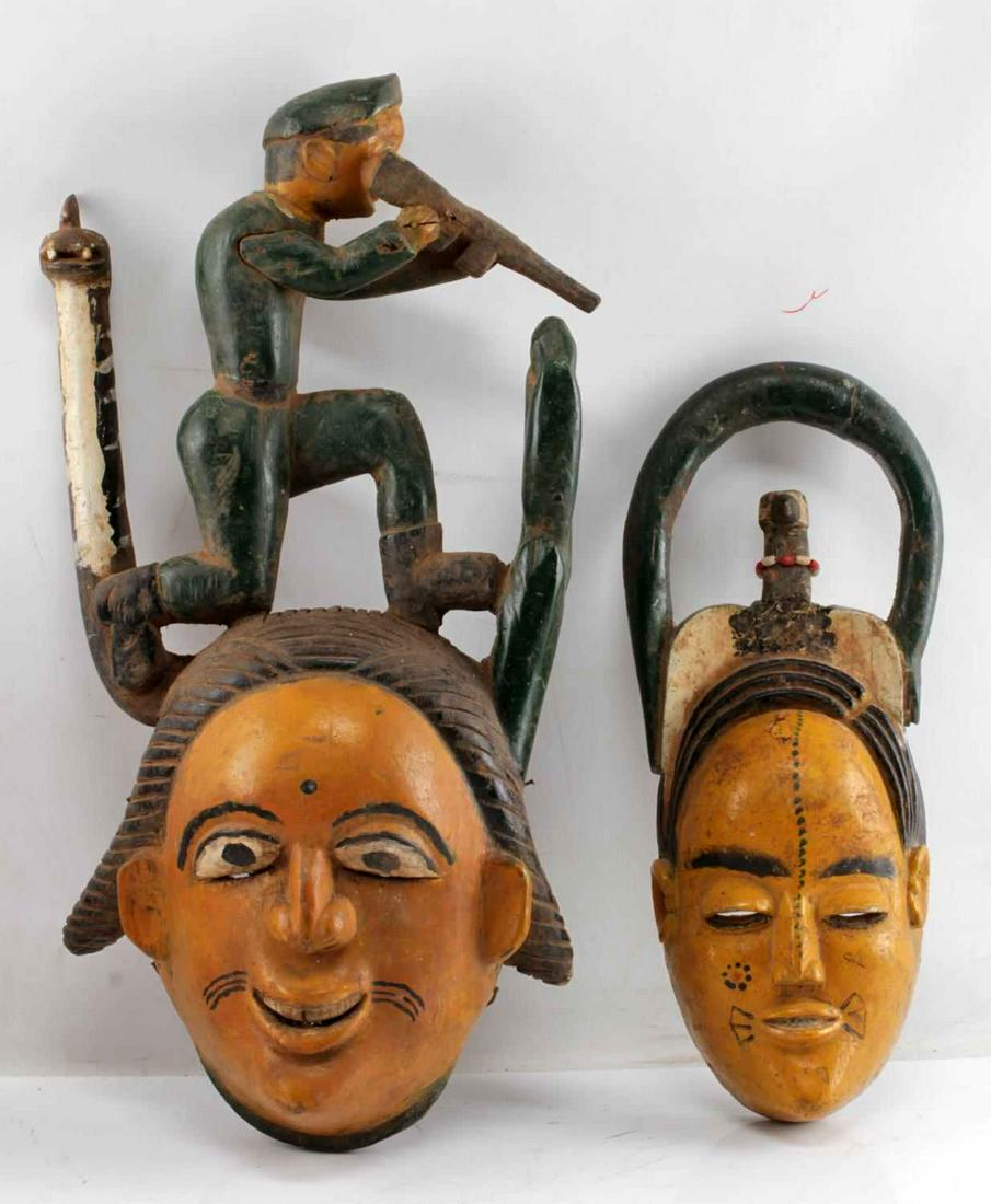 LOT OF TWO ANANG IBIBIO NIGERIA POLYCHROME MASKS: One mask showing bird with outstretched wings. Measures 16 inches by 3.5 inches by 7 inches. One mask with hunter at top. Measures 21 inches by 5 inches by 10.5 inches. Masks previously exhibited Exhi