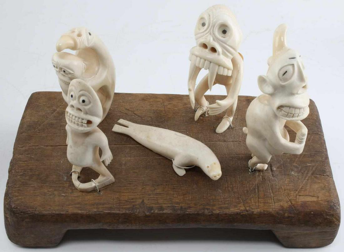 LOT OF 5 WALRUS GREENLAND INUIT TUPILAK CARVINGS: Greenland Inuit carvings of walrus and four Tupilaq monsters. Average measurement of 5 inches by 1.5 inches by 1 inch. All in very good condition. Can be removed from board for shipping. We will not s