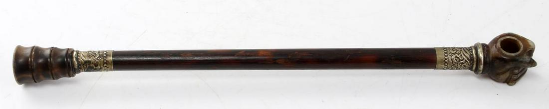 ANTIQUE ASIAN BAMBOO HORN AND JADE OPIUM PIPE: 17 inch pipe features a jade hand as the bowl, bamboo stem, horn mouthpiece, and silver plate fittings. Very good condition.