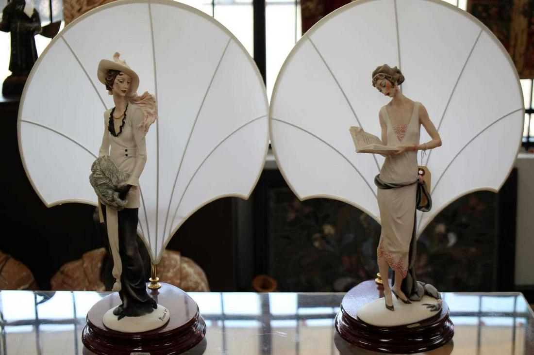 GIUSEPPE ARMANI VINTAGE ART DECO FIGURAL LAMPS: One lamp with figure of woman holding muff. One lamp with figure of flapper holding open book. 22.5 inches by 10 inches by 8.5 inches. Both in good condition.