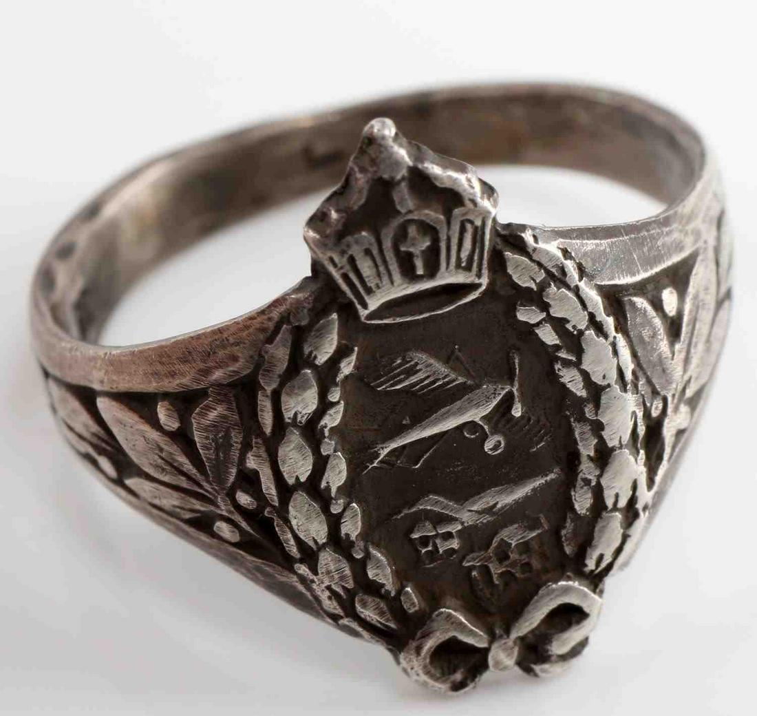 WWI PRUSSIAN FIGHTER PILOT SILVER CROWN RING: Genuine WWI Prussian fighter pilot silver ring. Ring features crown and oak leaves surrounding the fighter pilot. The ring is in 835 silver and is a size 10. Very good original condition This lot has 