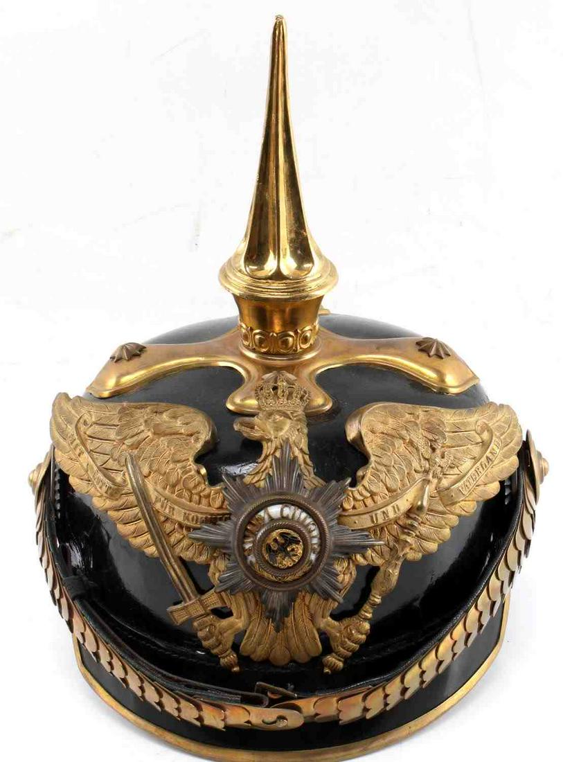WWI IMPERIAL PRUSSIAN OFFICERS PICKELHAUBE HELMET: WWI Imperial Prussian Officers Pickelhaube Helmet. The helmet has the long spike. The helmet has the officers fishscale chinstrap with the red artillery cockade on the right side of the helmet. The Or
