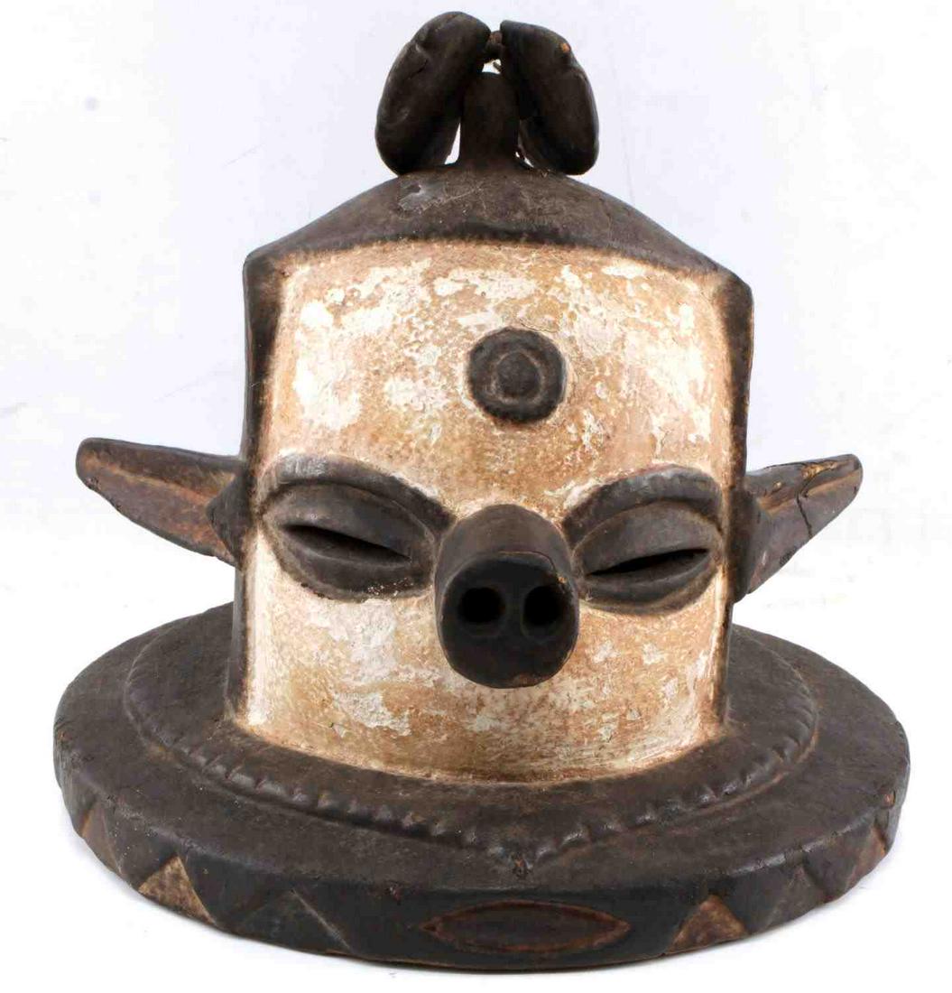 AFRICAN WOODEN HAT MASK PIG NOSE FISH ZOOMORPHIC: Large mask helmet with pointy ears, pig nose, and two fish on top. Has significant age but indeterminate. Measures 11 X 12 X 11 inches. Very good condition. This lot has a reserve.