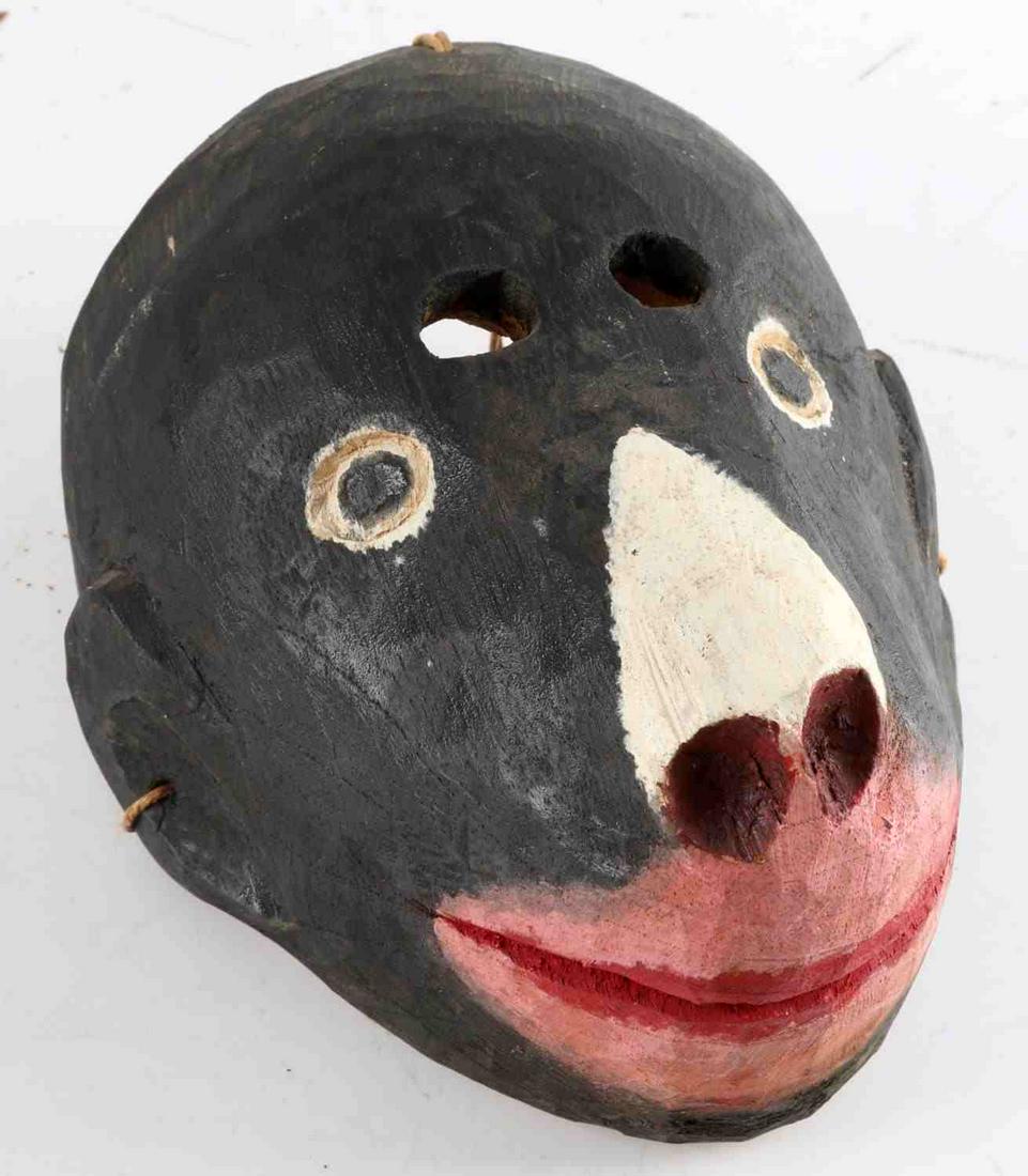 20TH C. CARVED GUATEMALAN WOODEN MONKEY MASK: Hand-carved and painted monkey mask with two holes at lower forehead for wearer. Made in Guatemala stamps to back. String hanger to back. Measures 7.5 X 6 X 5.5 inches. Ex-private Morgan collection, S