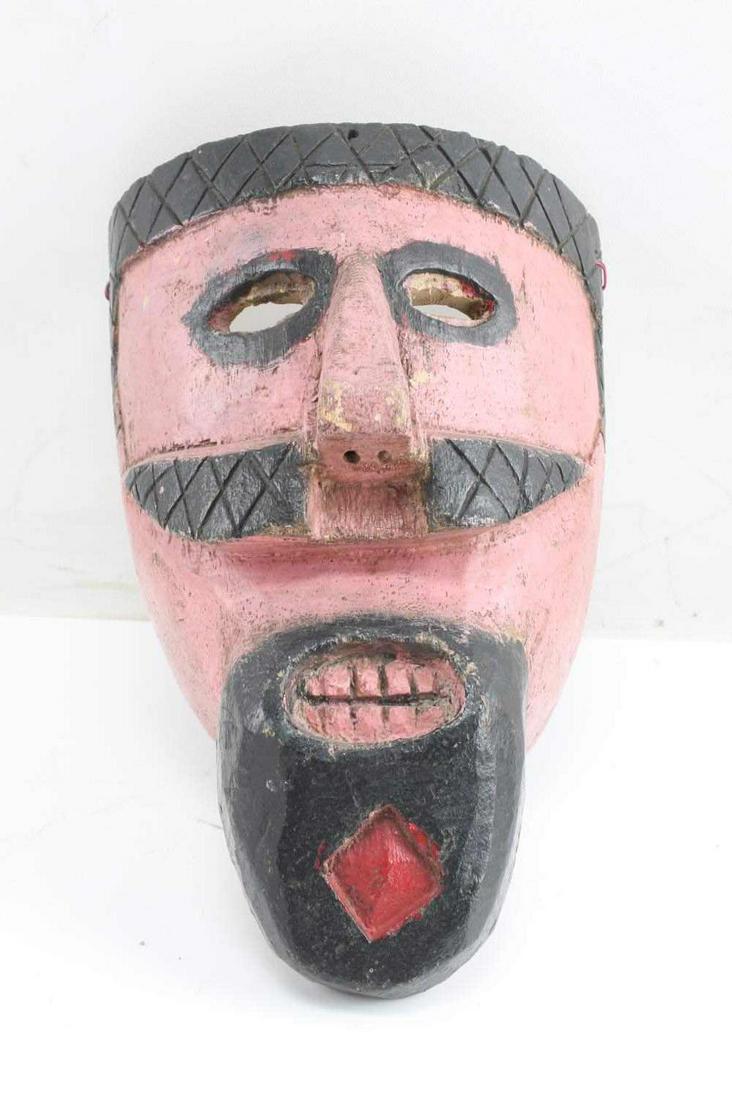 VINTAGE GUATEMALAN HAND CARVED WOODEN MASK: Male figure wooden mask with long beard with red diamond in the middle, cross hatch marks to top and mustache. 'Moro Pue' marked in marker to back. Measures 10.5 X 7 X 5.5 inches. This lot has a reser