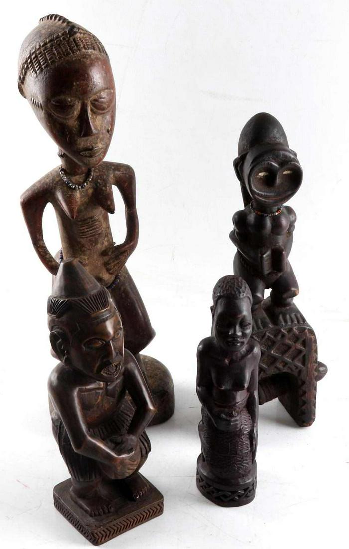 4 WOOD CARVING FIGURES YORUBA OCEANIC AFRICAN: One 18.5 inch Yoruba figure, one Oceanic male figure with drum, one muscular figure with heart-shaped face and spool at bottom, and one African woman figure. Very good condition.