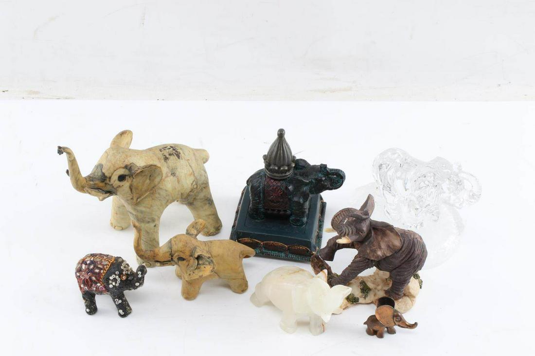 LOT ELEPHANT SCULPTURES WOOD METAL STONE GLASS: Lot of 8 small elephant figures fabricated from assorted materials: One white stone elephant measuring 4 inches by 1.5 inches, one plastic painted elephant measuring 4 inches by 3 inches, one glass el