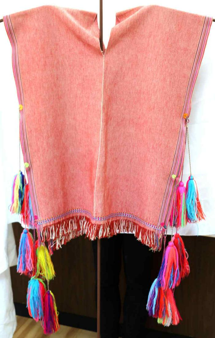 MENS PONCHO VEST FROM CHIAPAS MEXICO GIFT: Light red cotton poncho vest with pom poms at each side. Measures 29 X 23 inches. Very good condition. Gifted in 2002. This lot has a reserve.