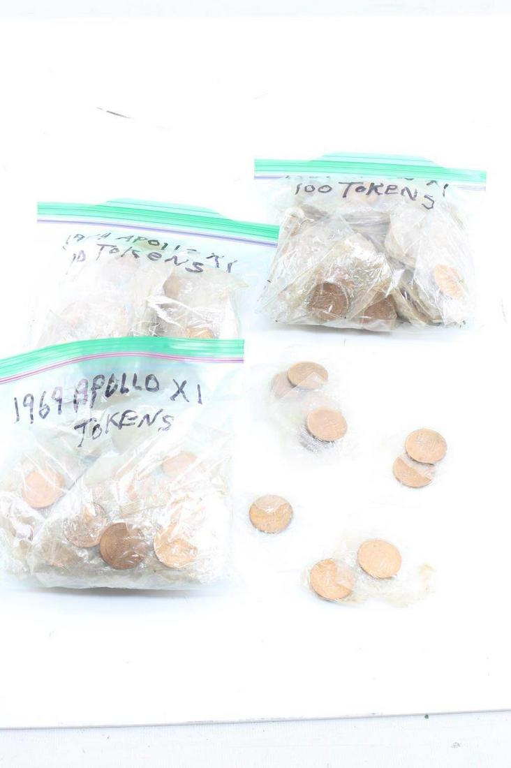 LOT 1969 APOLLO XI SEALED COMMEMORATIVE COINS: One lot of approximately 300 sealed commemorative 1969 Apollo XI coins. Each token measures 1 inch in diameter. Obverse reads "APOLLO XI" across the top, and "ARMSTRONG-ALDRIN-COLLINS" with an image o