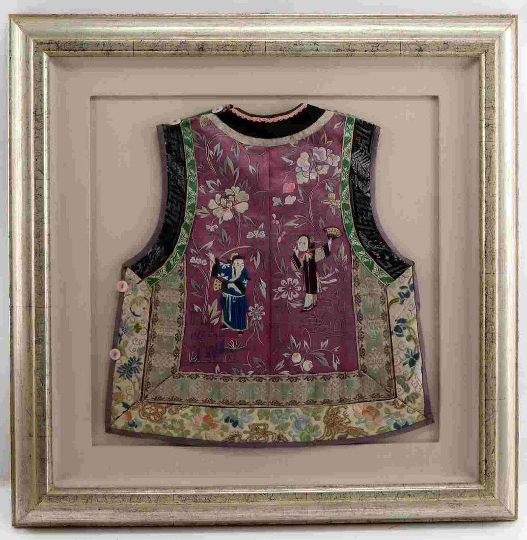 CHINESE SILK EMBROIDERED VEST CHILD: One hand-embroidered silk vest from China meant to be worn by a child, measuring 15 inches in length and 14 inches from hip to hip dating back to the late 19th or early 20th century. This vest emphasi