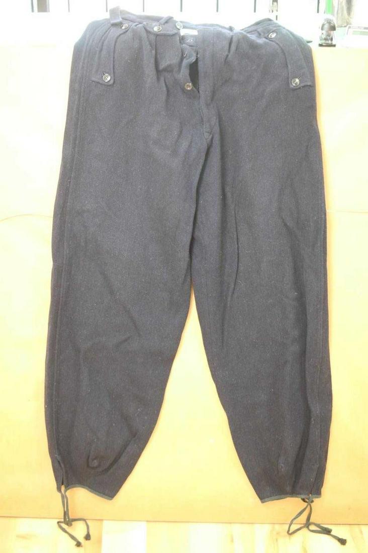WWII THIRD REICH GERMAN PANZER UNIFORM TROUSERS: One pair of men's blue wool Panzer trouser from WWII with a size 30 waist and measuring 39 inches in length. Waistband shows fraying and stretching and inner waistband and lining of pants are somewhat