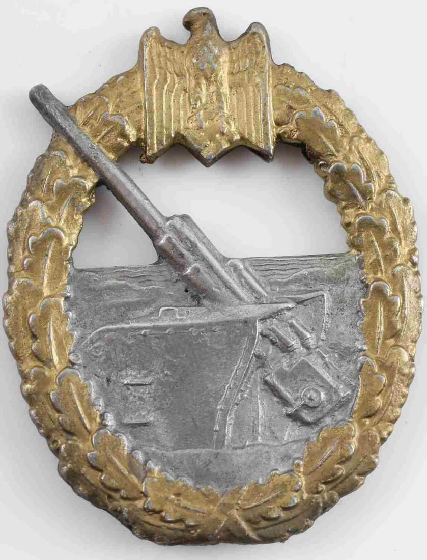WWII THIRD REICH KRIEGSMARINE ARTILLERY BADGE: 5X4 inches. Kriegsmarine coastal artillery badge. Awarded to crews of land based artillery and anti aircraft units. Missing pin back. Unauthenticated. Sold as is.