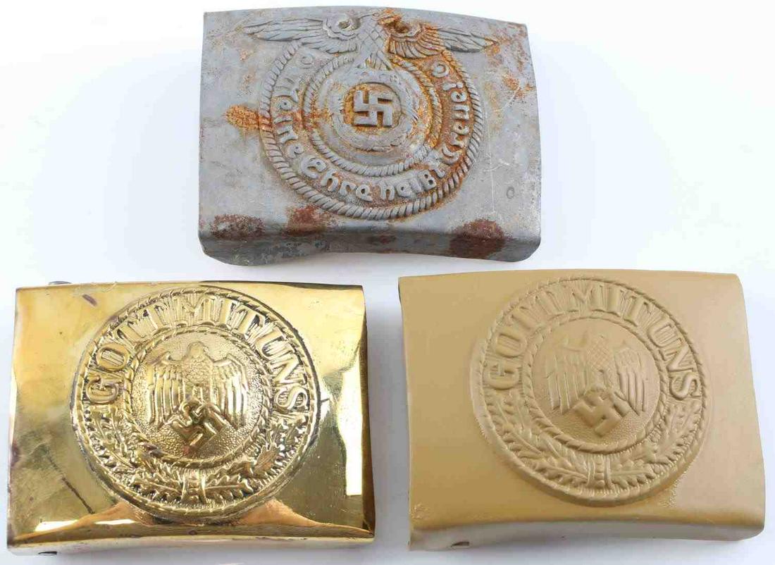 WWII GERMAN THIRD REICH BELT BUCKLE LOT OF THREE: WWII German Third Reich Belt Buckle Lot of Three. Lot includes one Heer Afrika Korps belt buckle, one Waffen SS belt buckle and one Kriegsmarine belt buckle. There is a heavy rust on the Waffen SS bel