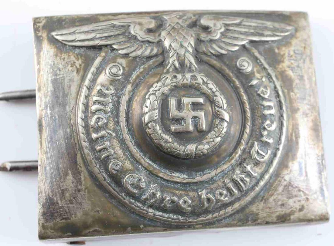 WWII GERMAN THIRD REICH SS BELT BUCKLE: WWII German SS belt buckle. Inscription reads "Meine Ehre Heist Treue" (My Honor is my Loyalty) and is engraved with Eagle and Swastika. Maker's mark. Unauthenticated. Sold as is. This lot has a reser