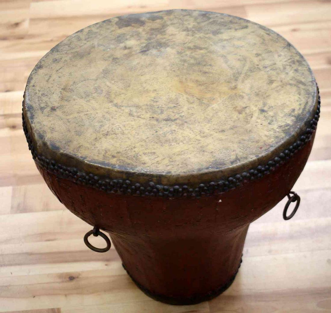 EAST AFRICAN UGANDAN TRIBAL STANDING DRUM: East African Ugandan Tribal Standing Drum. The drum has two heads and five strap loops for both ends of the drum to be played. The larger head measures 20 inches in diameter while the smaller head mea