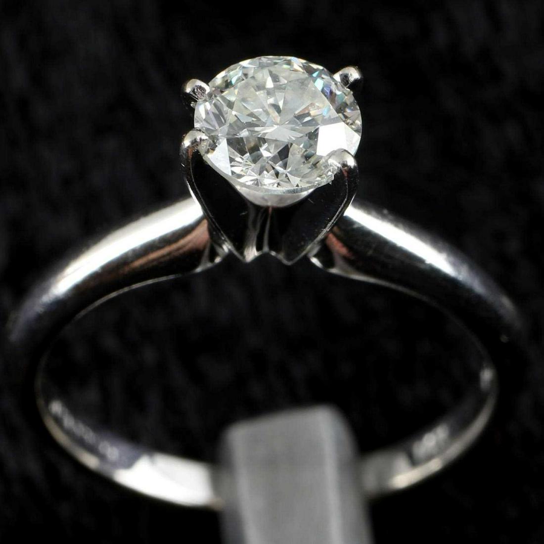 14K WHITE GOLD & DIAMOND SOLITAIRE ENGAGEMENT RING: 5.15 mm round cut diamond. Approximately .46 carats. Clarity: VVS1-VS1. Color: G-I. Size 5. Weighs total of 2.2 grams. Marked "Magic Glo" This lot has a reserve.
